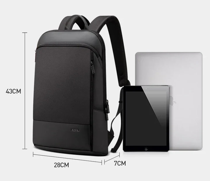 Black slim backpack with padded straps, measuring 43x28x7 cm, shown with tablet and laptop