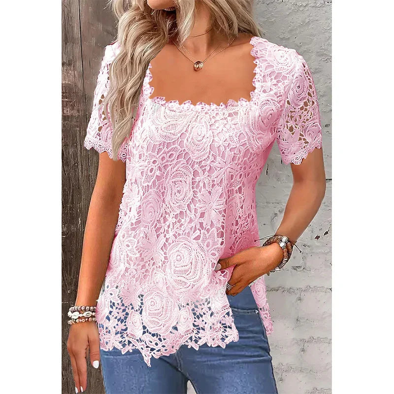 Woman wearing pink floral lace blouse with short sleeves and scalloped neckline