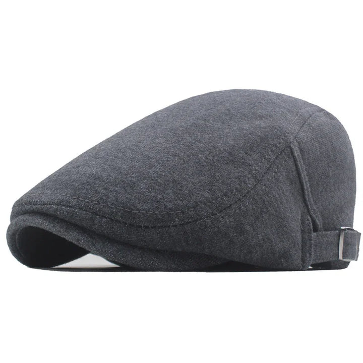 Dark gray wool flat cap with adjustable strap on white background
