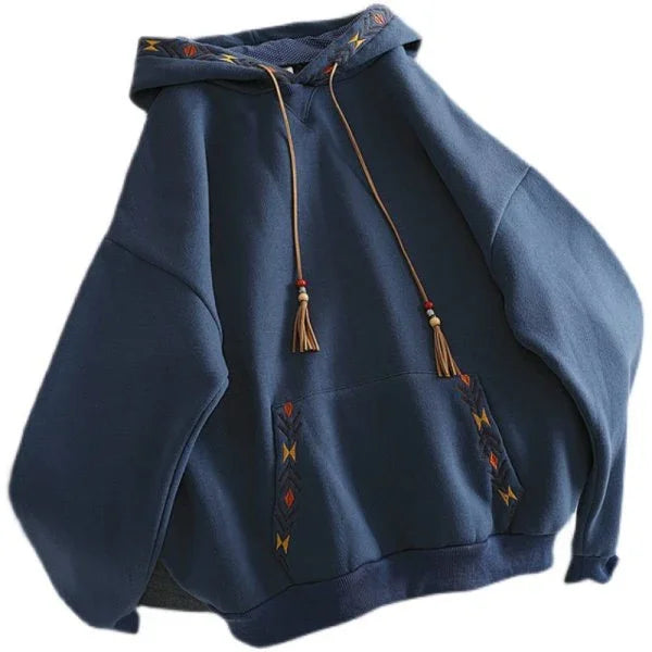 Blue oversized hoodie with embroidered geometric designs and tassel drawstrings