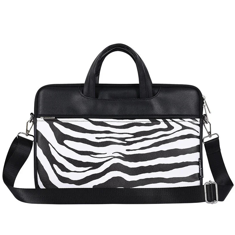 Black and white zebra print laptop bag with black handles and adjustable shoulder strap