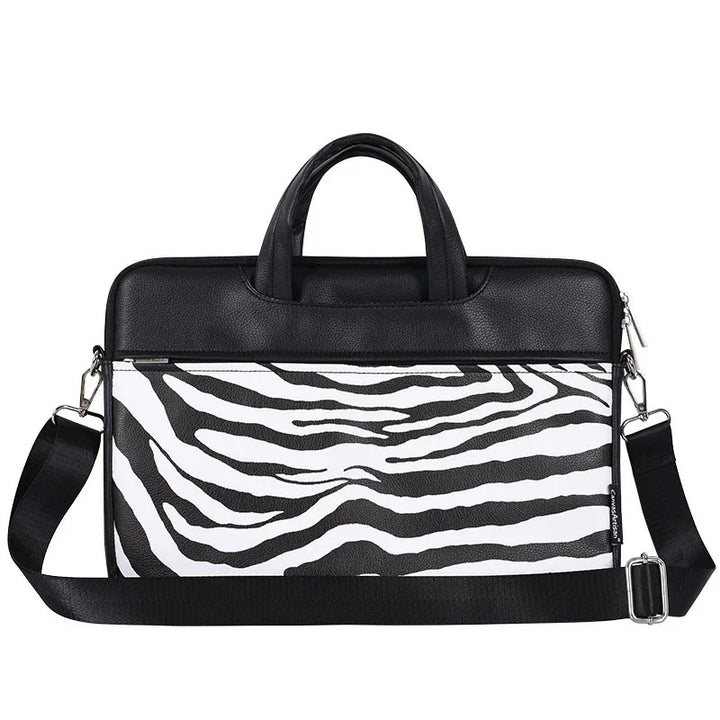 Black and white zebra print laptop bag with black handles and adjustable shoulder strap