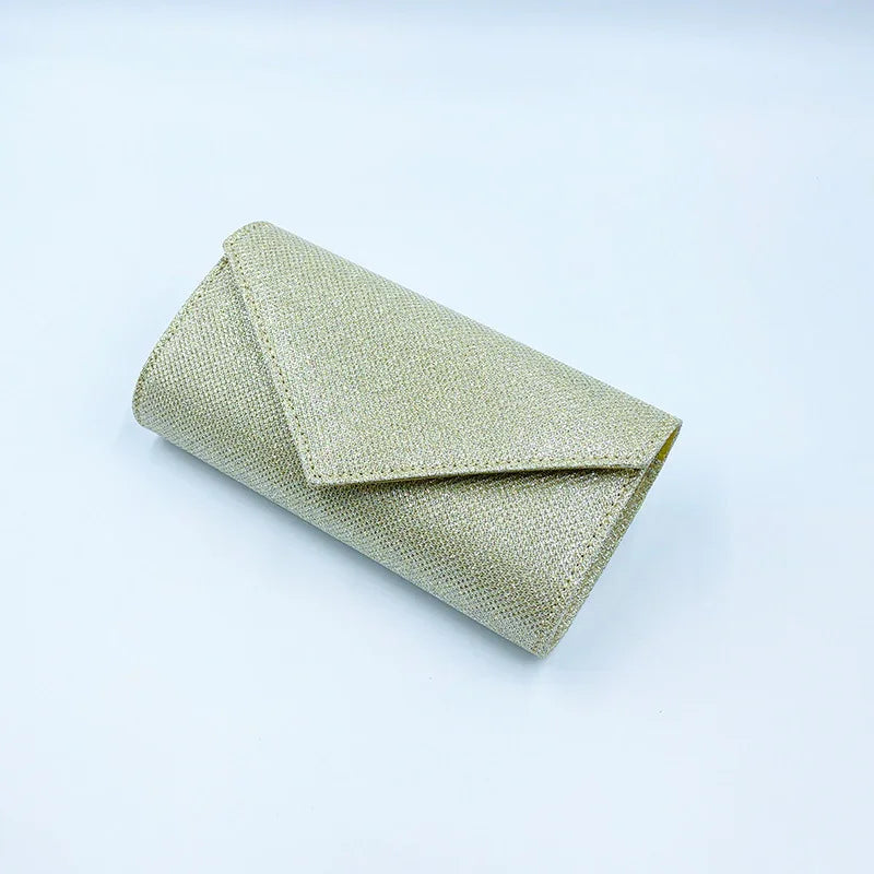 sparkling gold glitter envelope clutch purse on white background