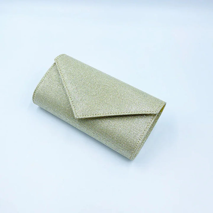 sparkling gold glitter envelope clutch purse on white background