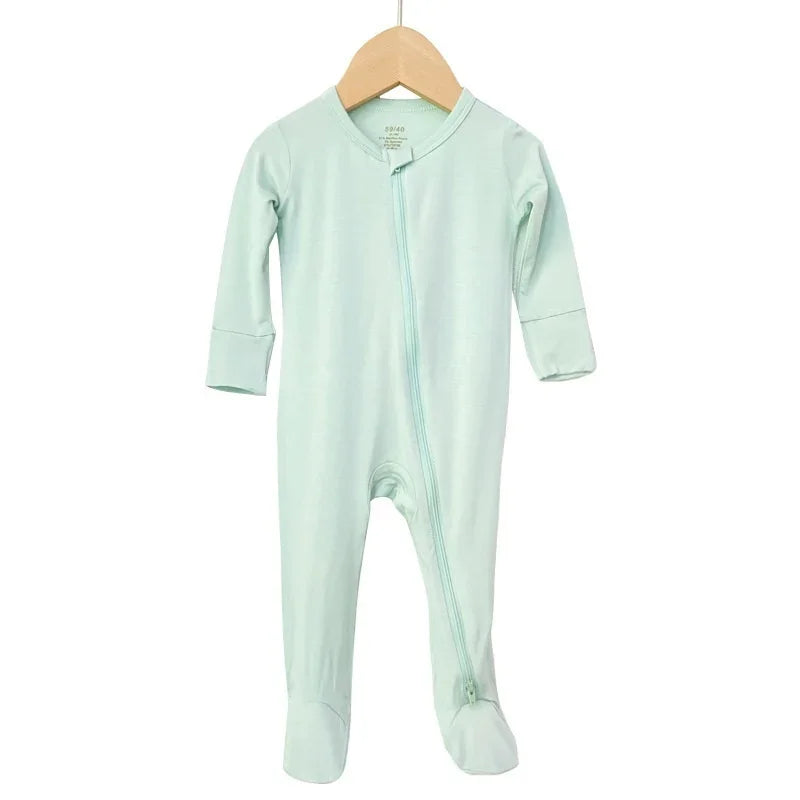 Soft mint green baby footed onesie with long sleeves and diagonal zipper on wooden hanger