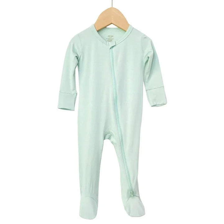 Soft mint green baby footed onesie with long sleeves and diagonal zipper on wooden hanger