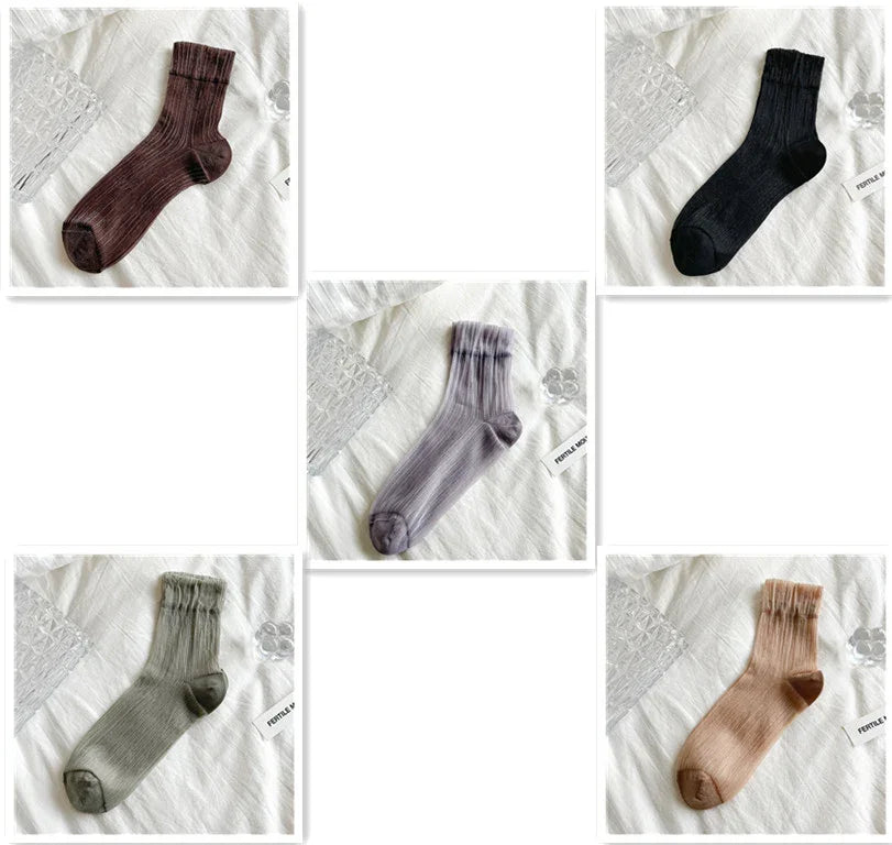 Five pairs of ribbed ankle socks in brown, black, gray, green, and beige on white fabric