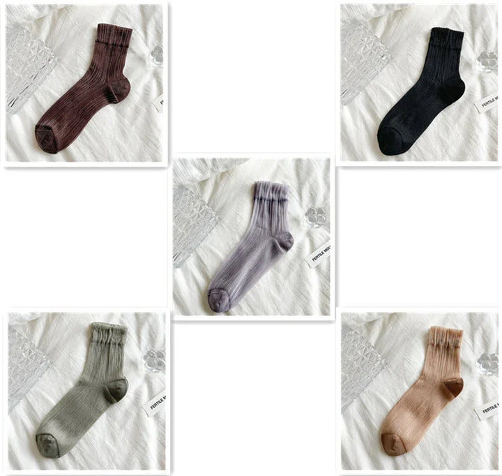 Five pairs of ribbed ankle socks in brown, black, gray, green, and beige on white fabric