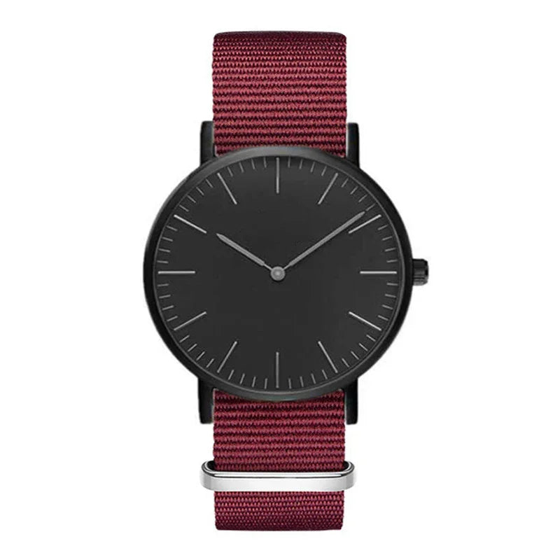 Minimalist black watch with burgundy fabric strap and slim markers on dial