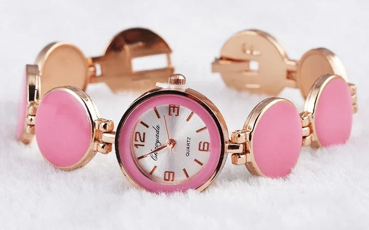 Elegant pink and gold women's quartz bracelet watch with round links on white background