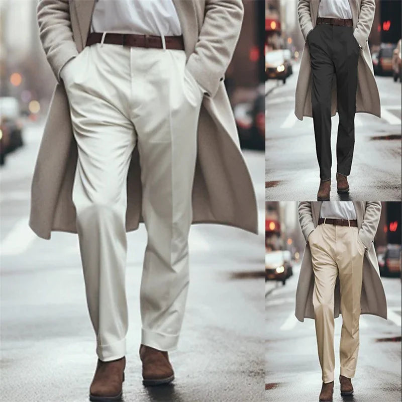 Men's tailored trousers in white, black, and beige paired with brown boots and beige overcoat on city street