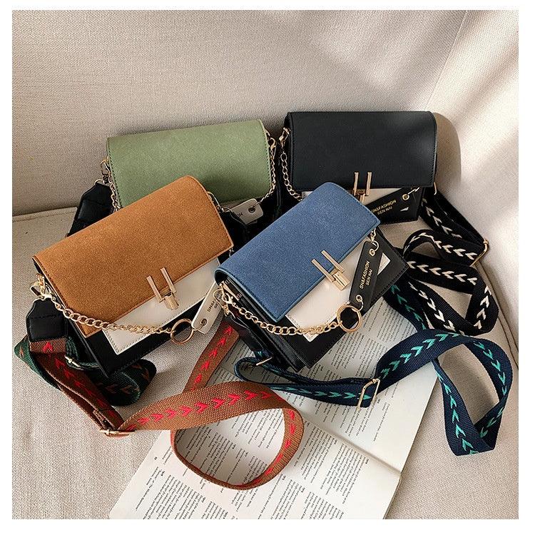 Four stylish crossbody bags in black, brown, blue, and green with gold chain accents and patterned straps on fabric background