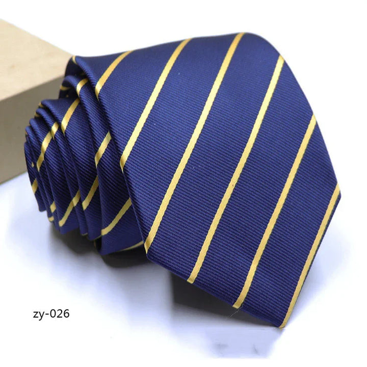 Blue necktie with diagonal yellow stripes rolled up on white background