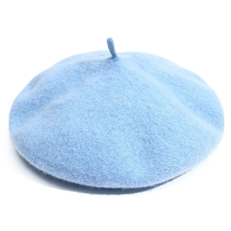Soft light blue wool beret with classic shape on white background