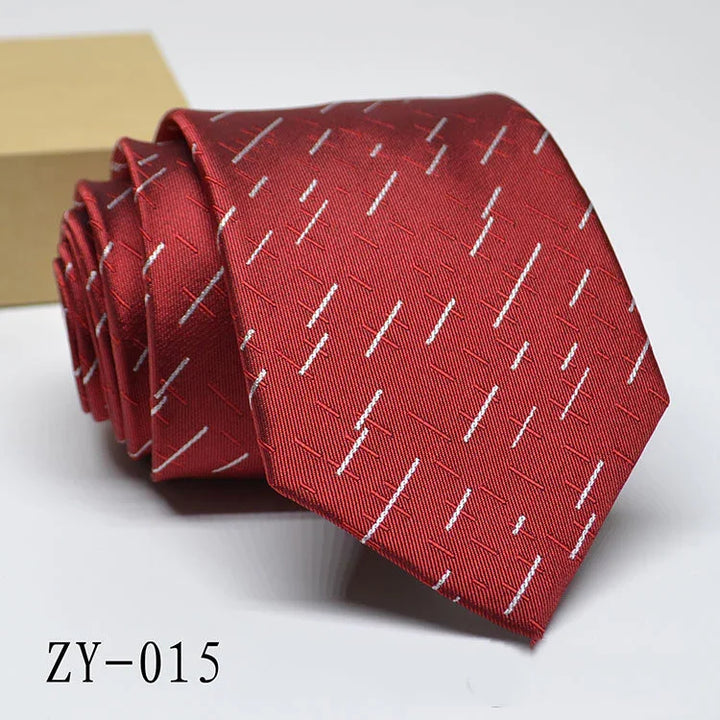 Red silk necktie with white diagonal stitch pattern, neatly rolled on white background
