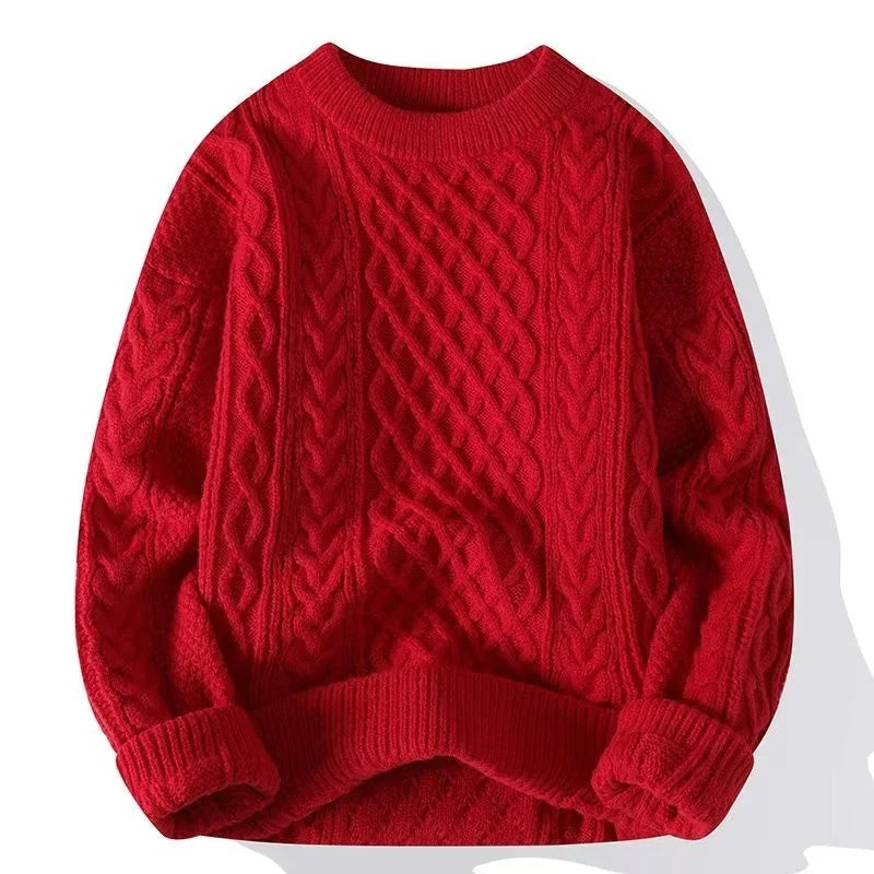 Red cable knit sweater with round neckline and textured pattern laid flat