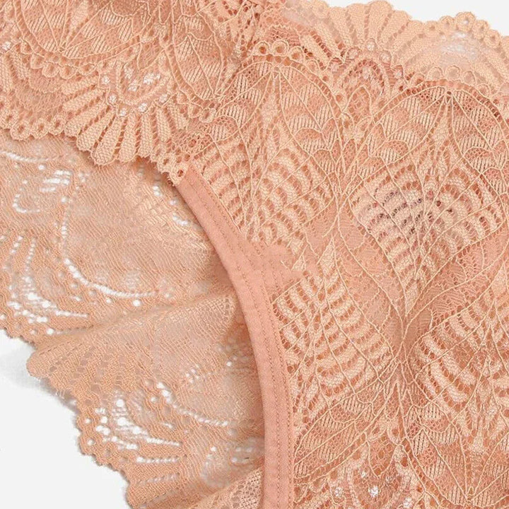 Close-up of peach-colored lace lingerie with intricate floral and leaf patterns