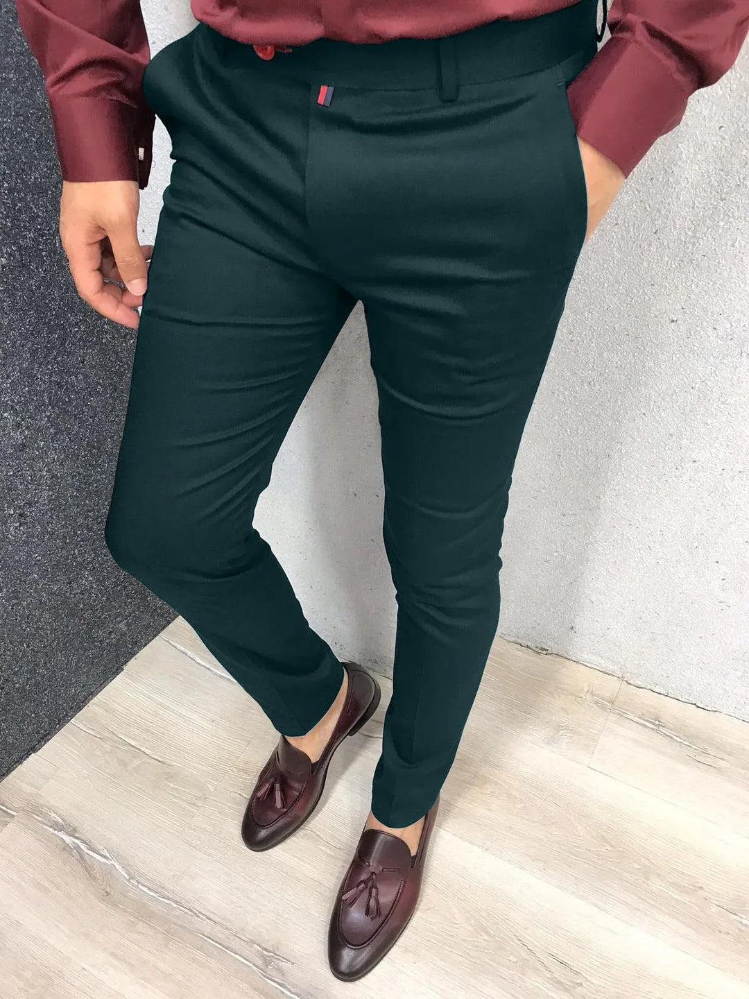 Man wearing slim-fit black dress pants paired with brown tassel loafers and a maroon shirt