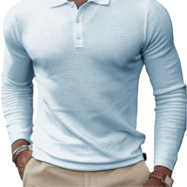 Man wearing light blue textured long-sleeve polo shirt with beige pants, wristwatch, and bracelets