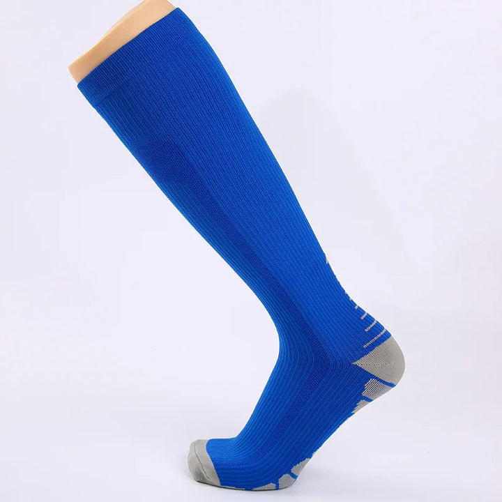 Blue knee-high athletic sock with gray heel and toe on a foot mannequin