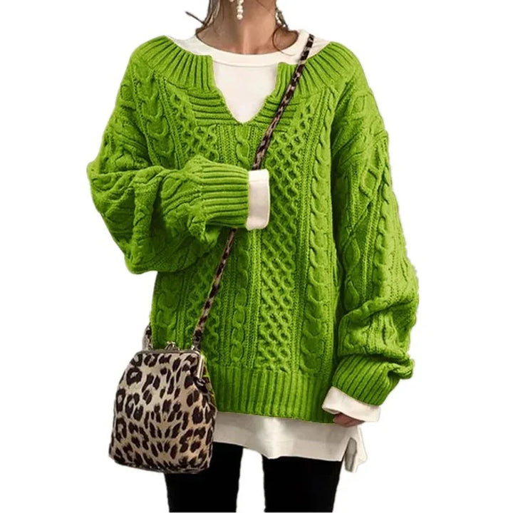 Woman wearing bright green cable knit sweater with white layering and leopard print crossbody bag