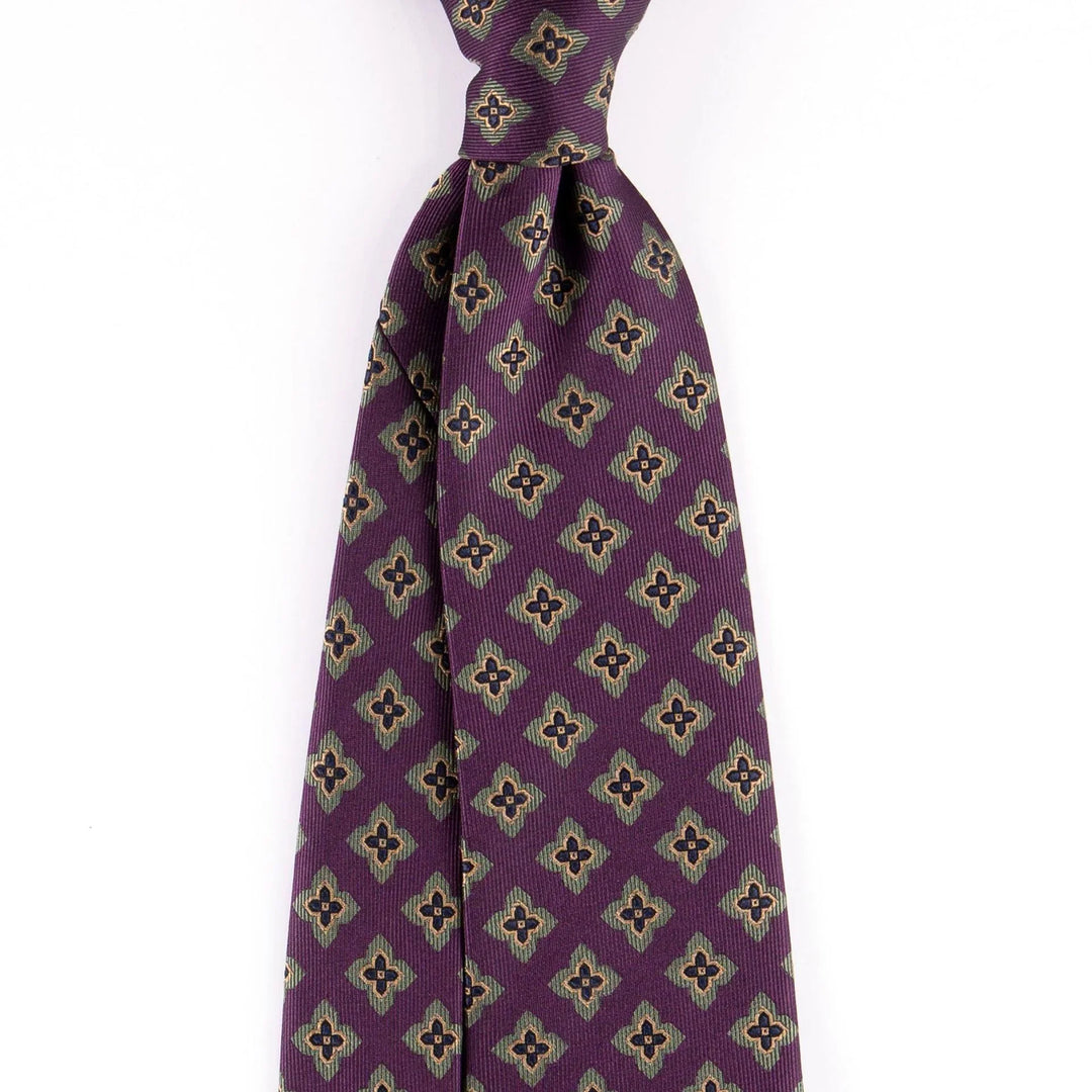 Purple patterned men's necktie with geometric floral design on white background