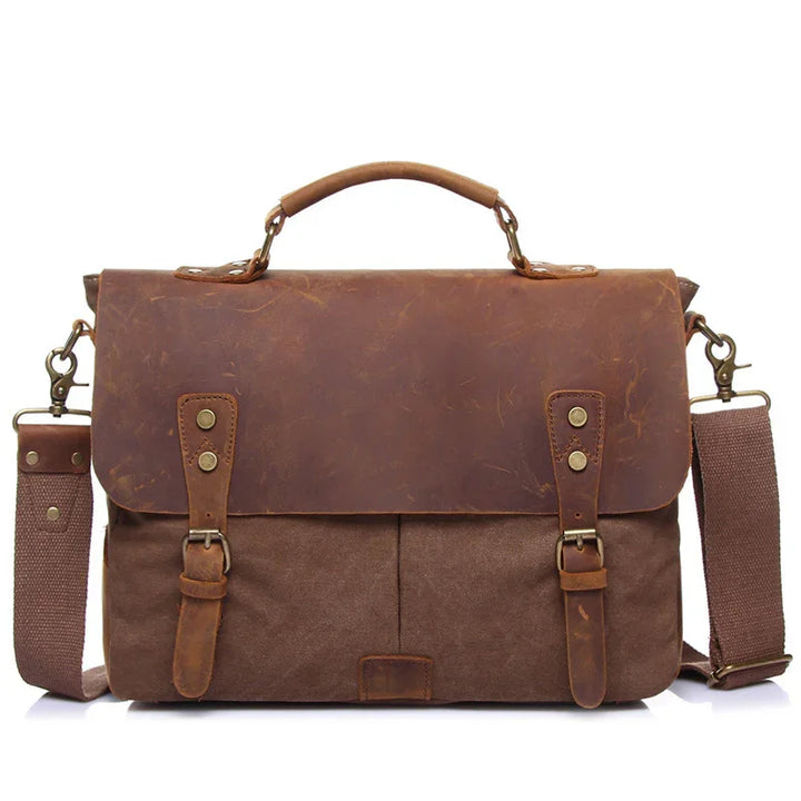 brown leather and canvas messenger bag with adjustable shoulder strap and top handle