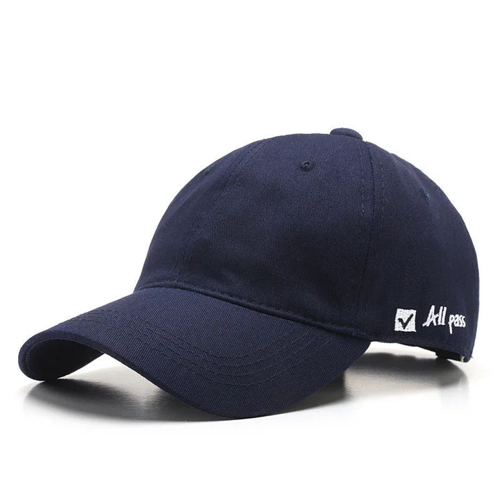 navy blue baseball cap with curved brim and embroidered checkmark with text 'All pass' on side