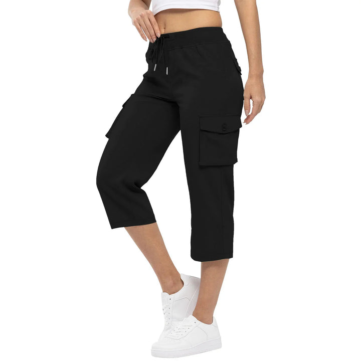 Woman wearing black capri cargo pants with drawstring waist and white sneakers