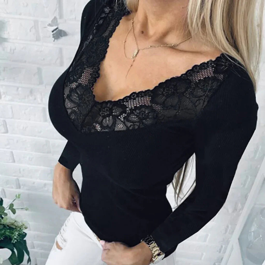 Woman wearing black long-sleeve top with lace V-neck detail and white ripped jeans