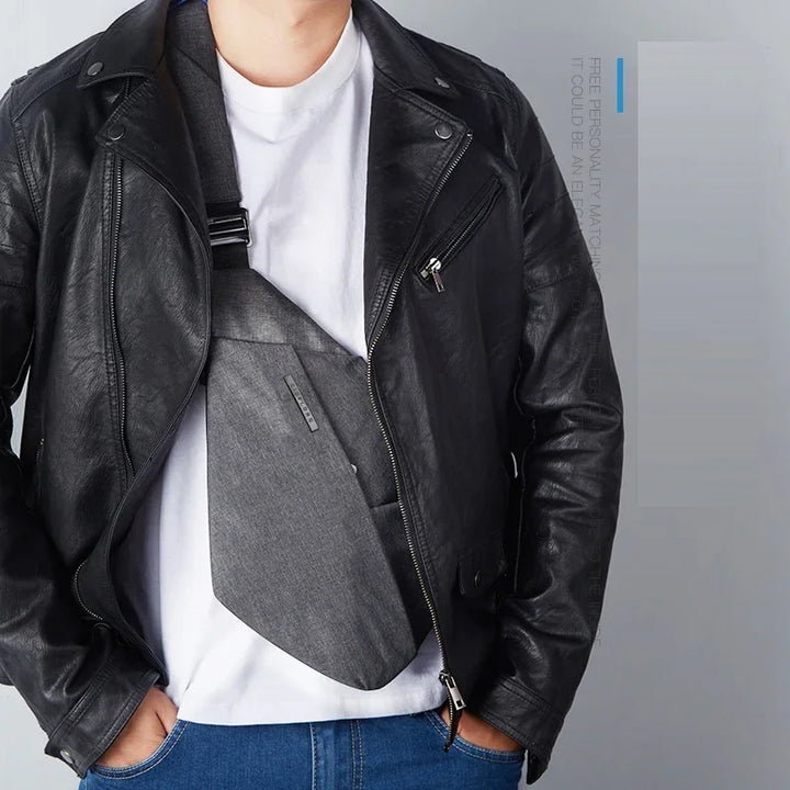 Man wearing black leather jacket with gray crossbody sling bag and white t-shirt