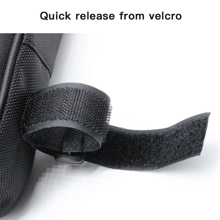 Close-up of black quick release velcro strap on textured fabric bag