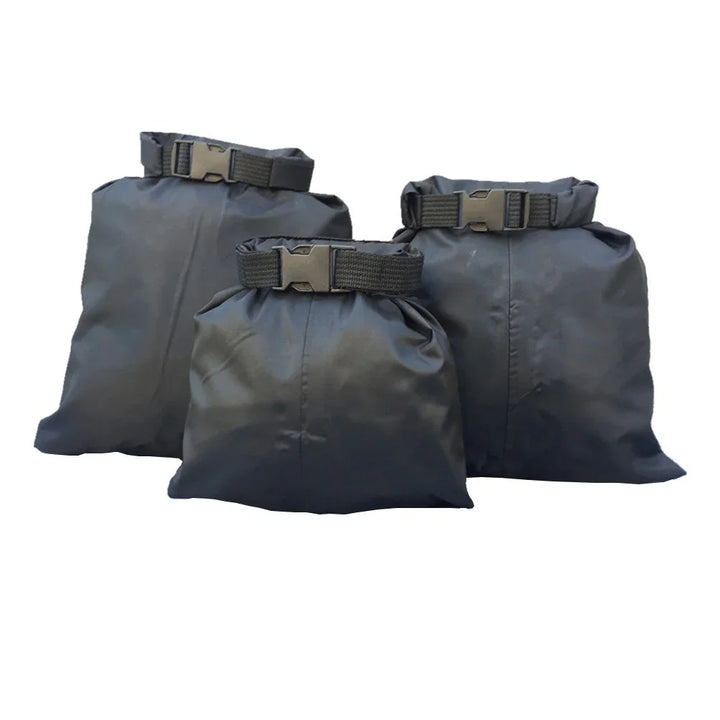 Set of three black waterproof dry bags with buckle closures on a white background