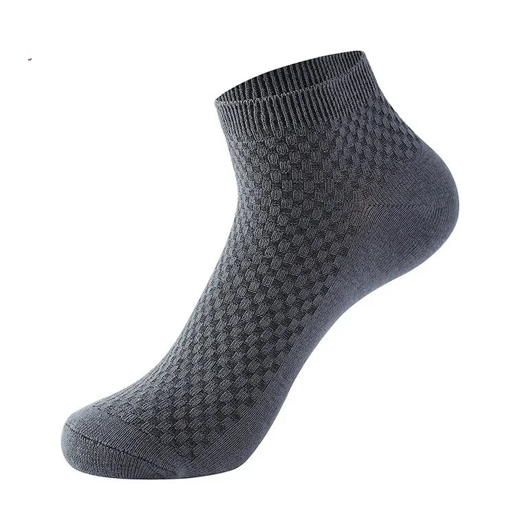 Dark gray ankle sock with textured diamond pattern and ribbed cuff on white background
