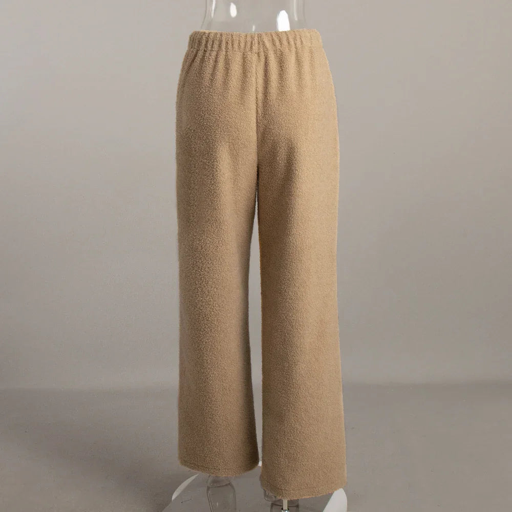 Beige wide-leg fleece pants with elastic waistband on a mannequin against gray background