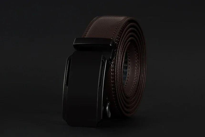 Rolled brown leather belt with black automatic buckle on black background