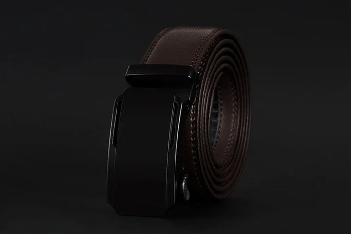 Rolled brown leather belt with black automatic buckle on black background