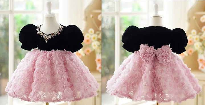 Black velvet baby dress with puff sleeves and pink 3D floral skirt on dress form