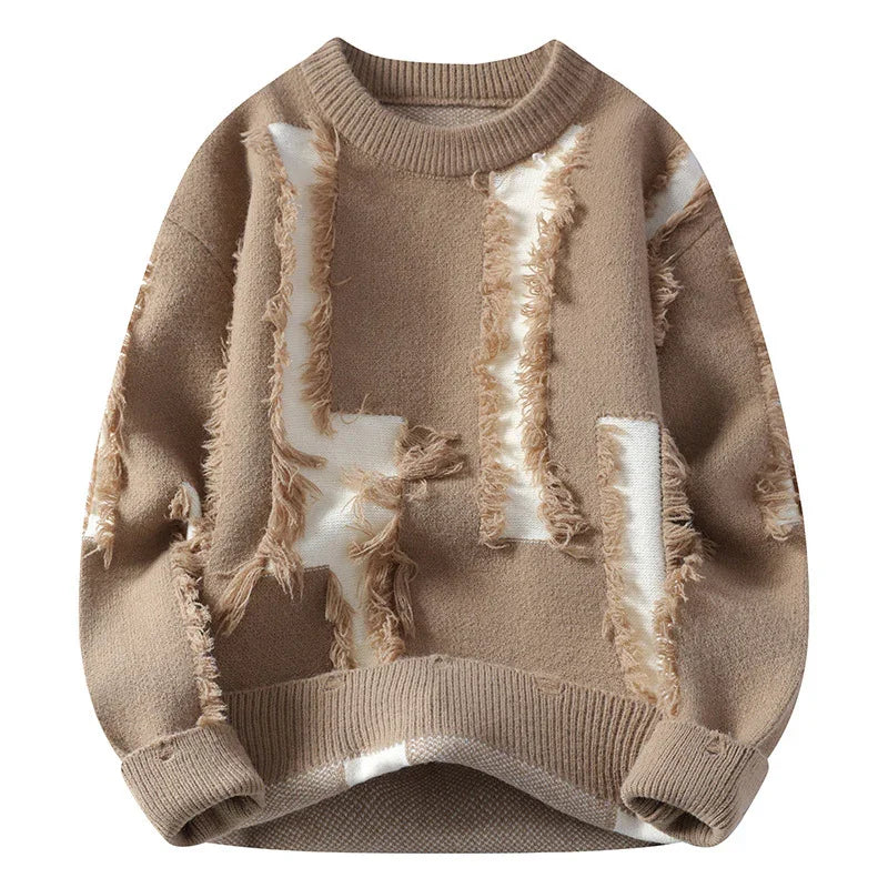 Beige wool knit sweater with distressed white patch detailing and ribbed cuffs and hem