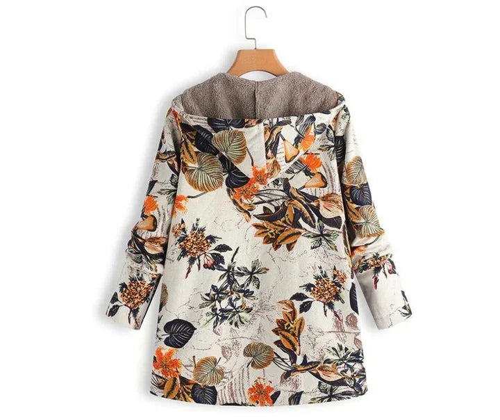 Back view of floral print hoodie jacket with brown sherpa lining and rolled-up sleeves on hanger