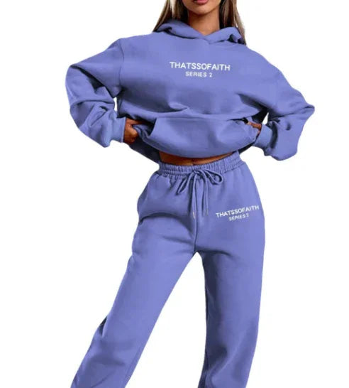 Woman wearing lavender blue hoodie and sweatpants set with THATSSOFAITH SERIES 2 logo
