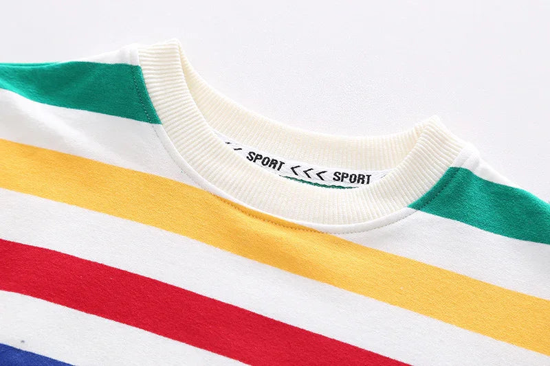 Close-up of colorful striped crewneck shirt with green, yellow, red, and blue stripes and a ribbed white collar
