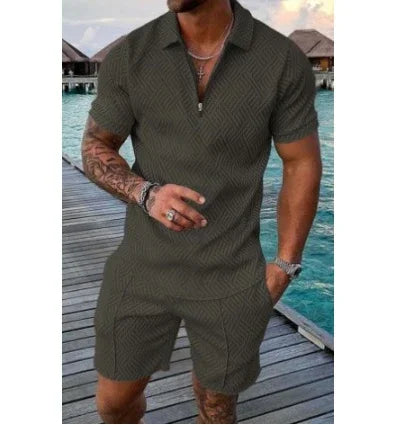 man wearing dark green short-sleeve shirt and shorts set standing on wooden dock by blue water