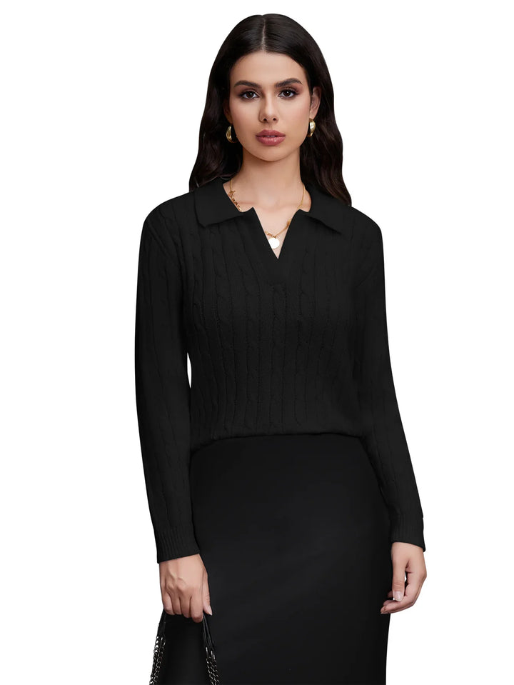 Woman wearing black cable knit sweater with collar and black skirt holding handbag