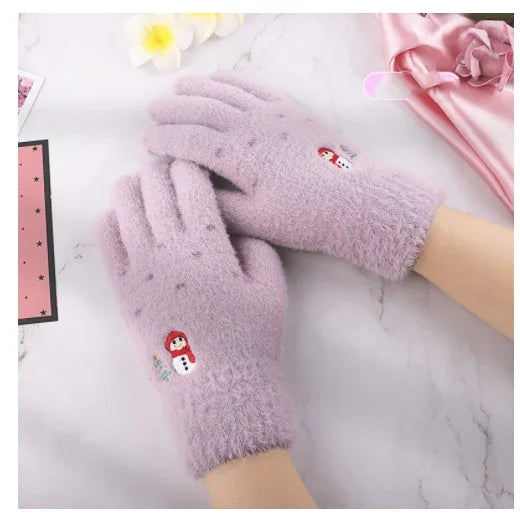 Soft lavender fuzzy gloves with cute snowman embroidery on a marble surface