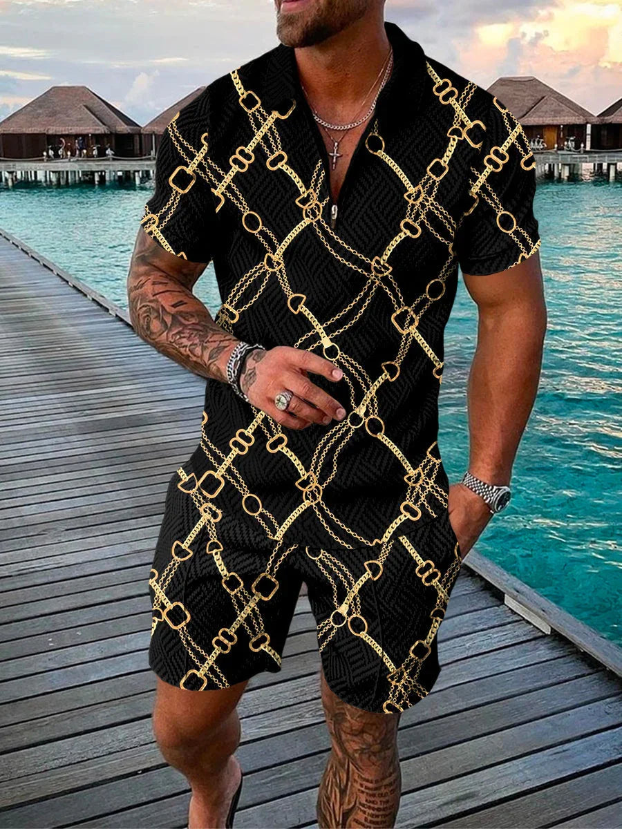 Man wearing black short-sleeve shirt and shorts with gold chain print on a wooden dock by tropical water villas