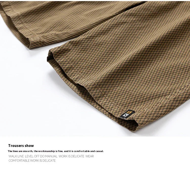 Close-up of brown checkered casual trousers with fine stitching and small black tag