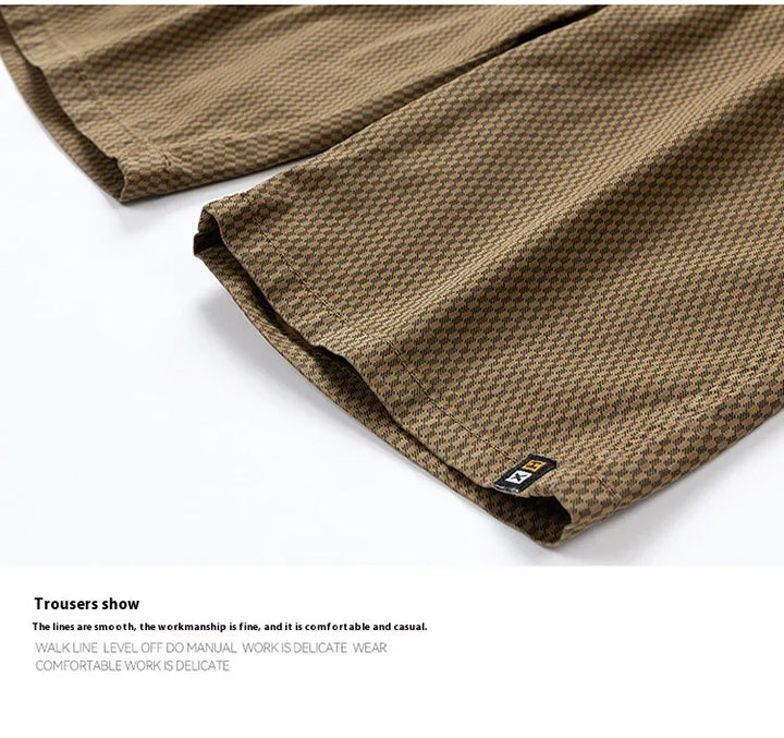 Close-up of brown checkered casual trousers with fine stitching and small black tag