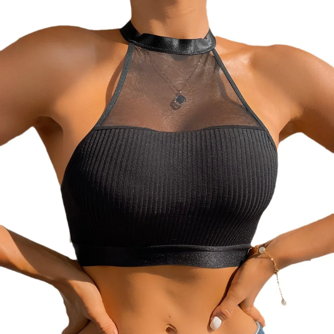 Woman wearing black ribbed crop top with sheer mesh neckline and satin choker collar