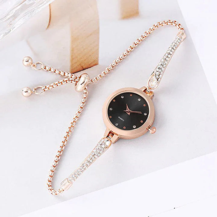 Elegant rose gold women's bracelet watch with black dial and crystal embellishments